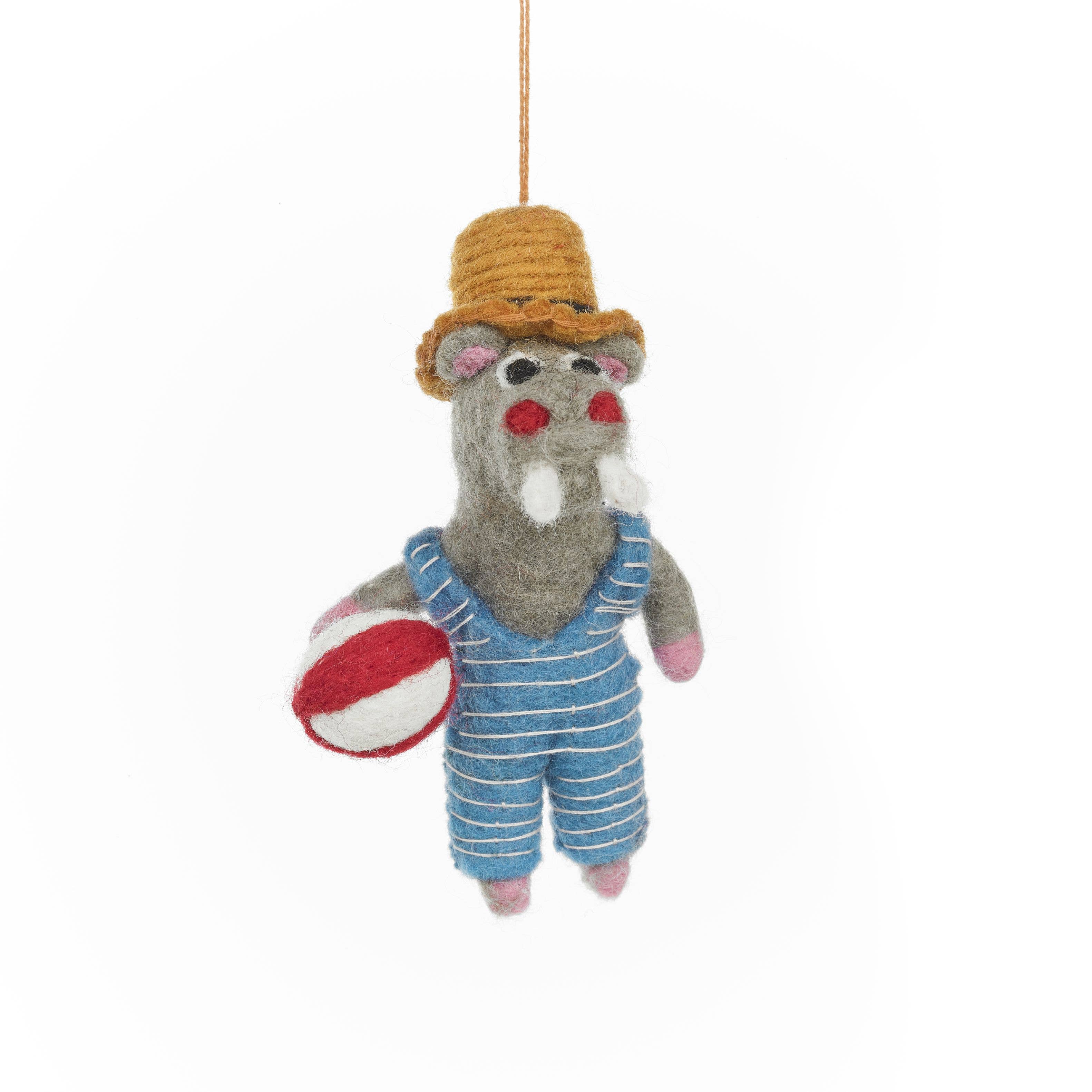 Felt hippo ornament in overalls and hat with a ball