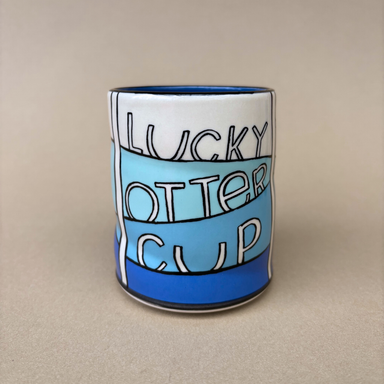 Lucky Otter Cup showcasing the text 'LUCKY OTTER CUP' in colorful lettering, crafted by The Bowl Maker.