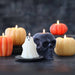 Halloween-themed candles including a skull, ghost, and pumpkins 