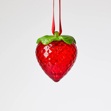 Red strawberry-shaped glass ornament with green leaves 