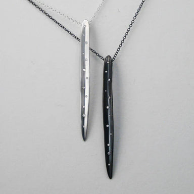 Two long, thin pendants with small diamonds on a chain