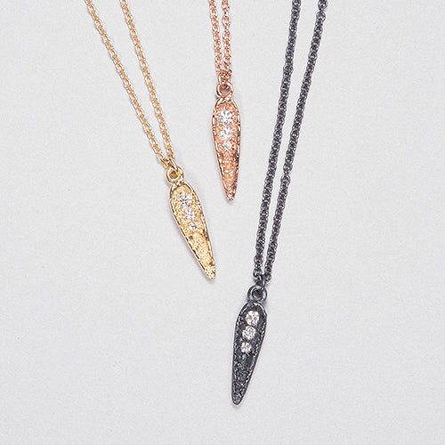 Three diamond-studded necklace pendants