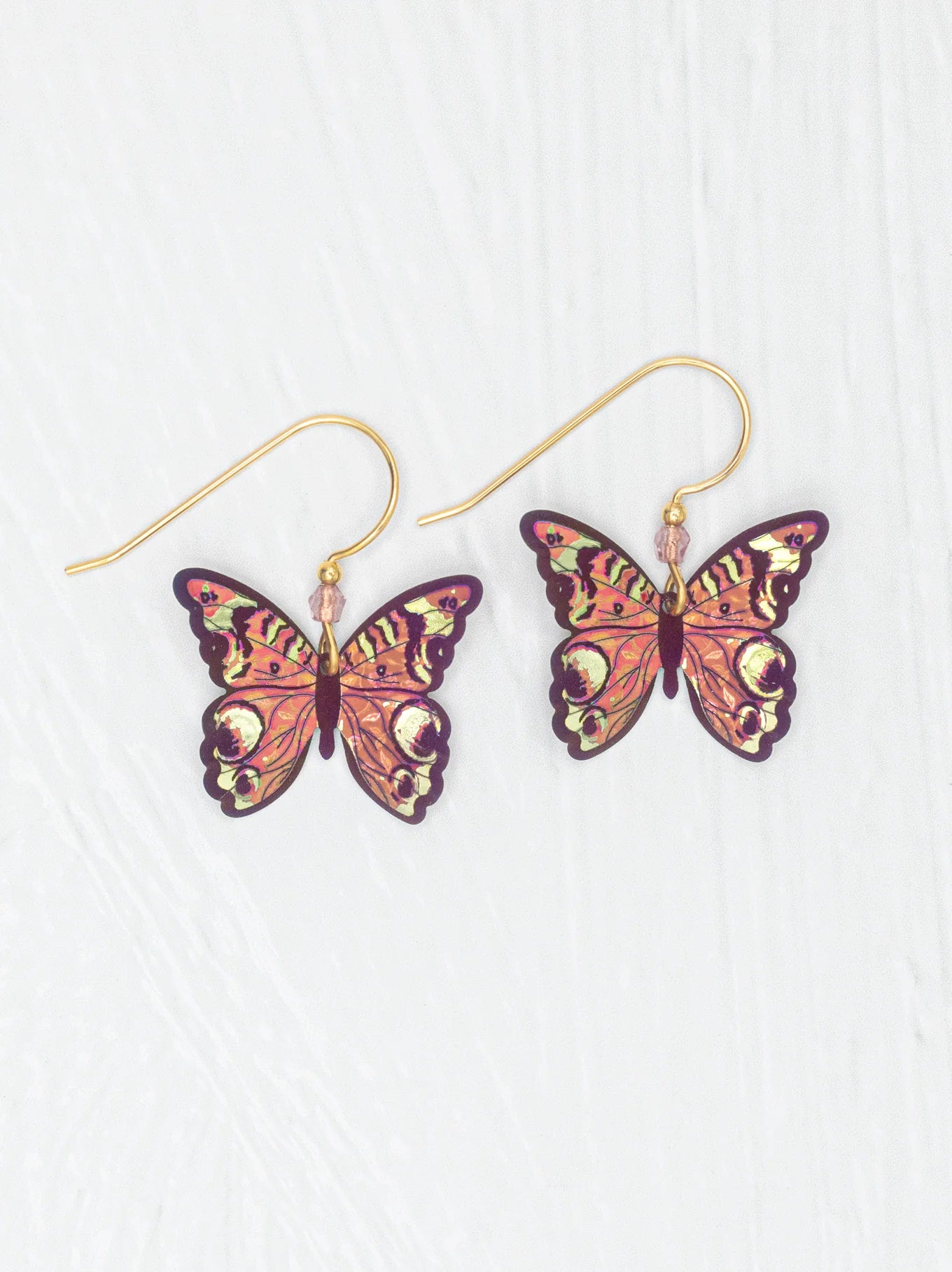 Close-up view of Mariposa Butterfly Earrings, highlighting the intricate craftsmanship and captivating colors that change in light, making each piece a unique accessory.