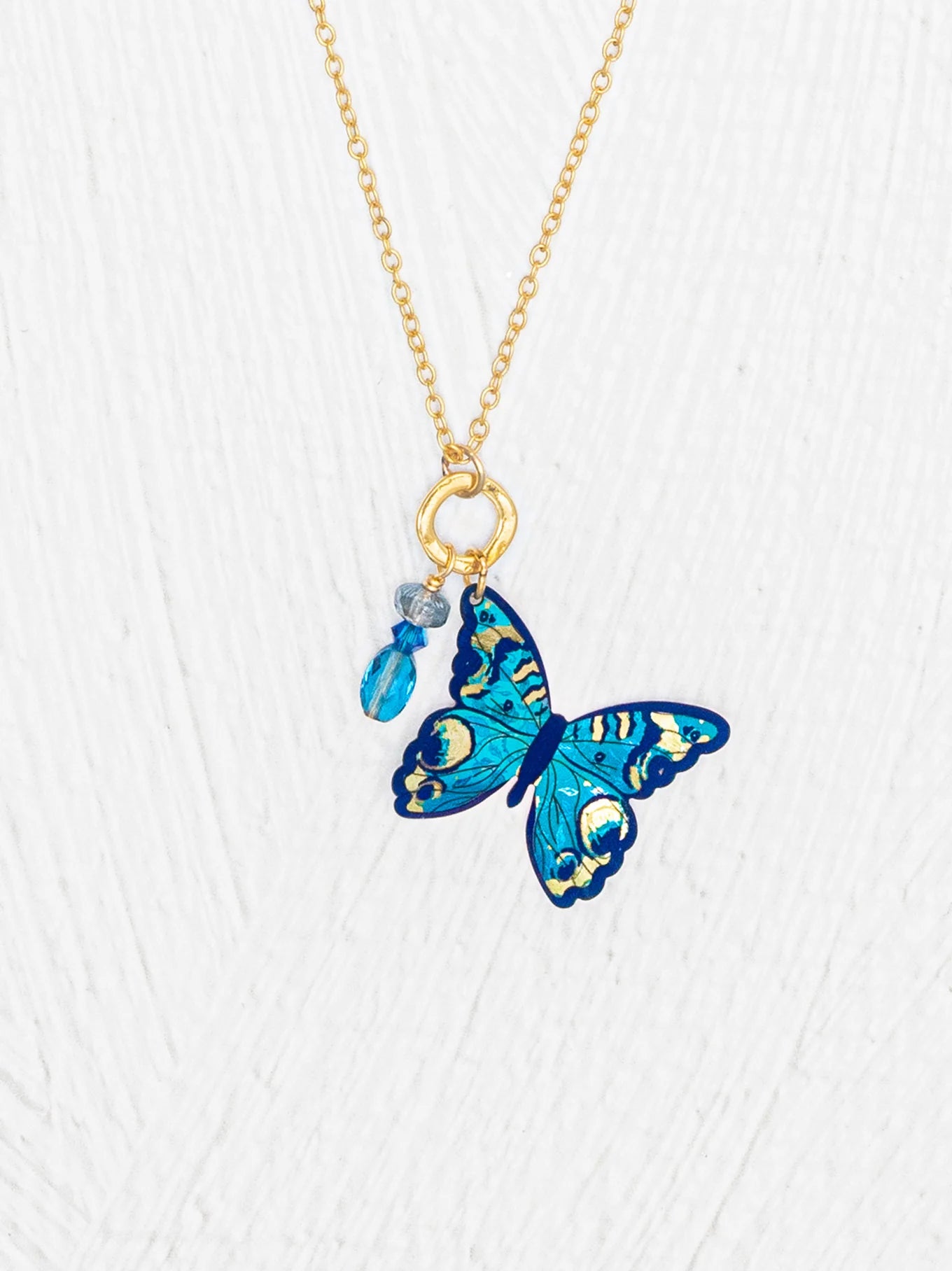 Mariposa Butterfly Charm Pendant Necklace featuring a stunning handcrafted design, made with niobium, 18K gold-plated accents, and adorned with crystal and amethyst, showcasing a beautiful play of color and texture.