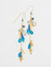 Calliope Earrings designed by Holly Yashi featuring niobium and gold leaves, adorned with quartz, crystals, and natural gemstones, showcasing a playful and polished cascade design.