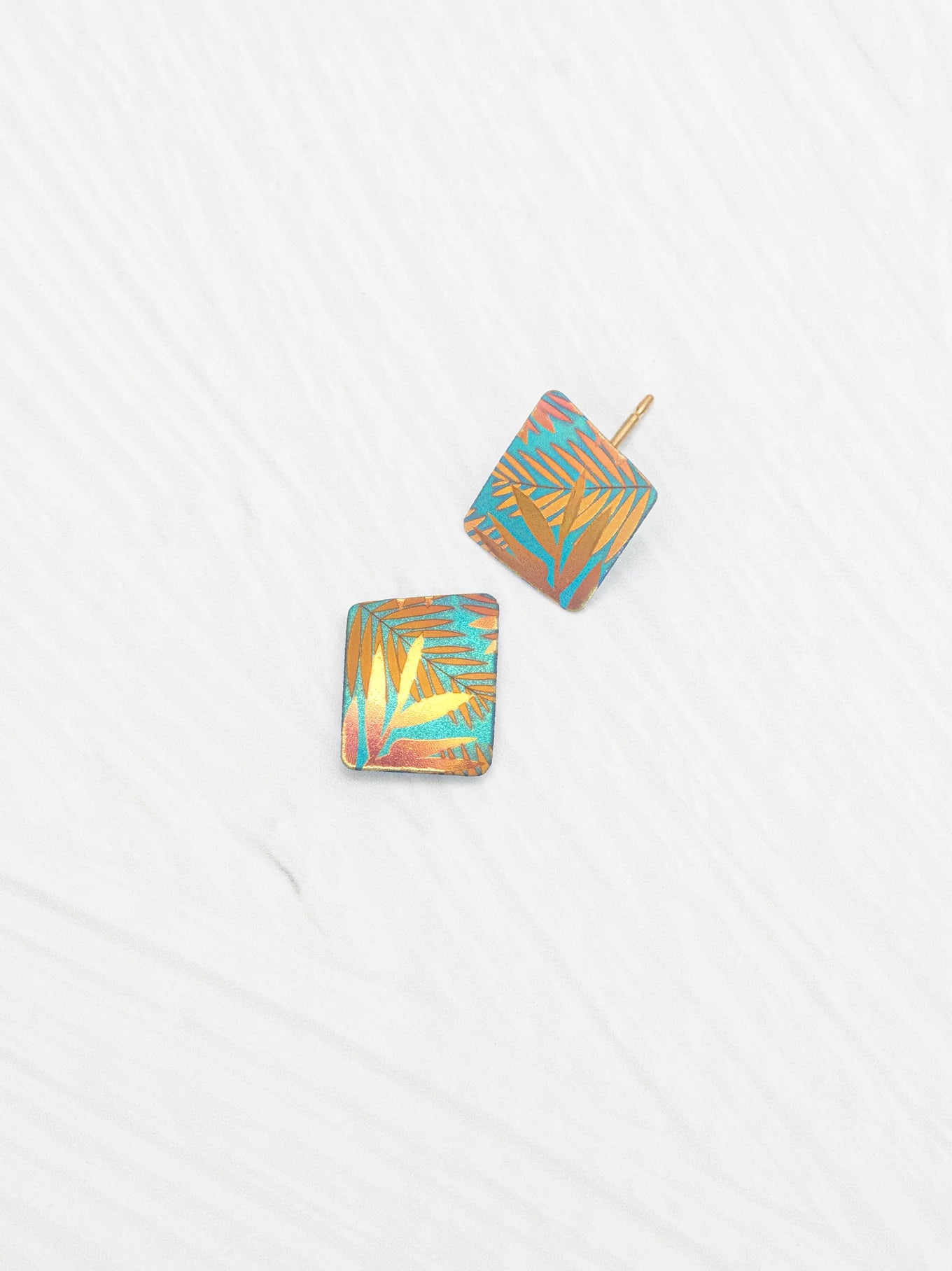 Close-up view of Rae Stud Earrings by Holly Yashi, highlighting the intricate niobium material and elegant gold fill posts.