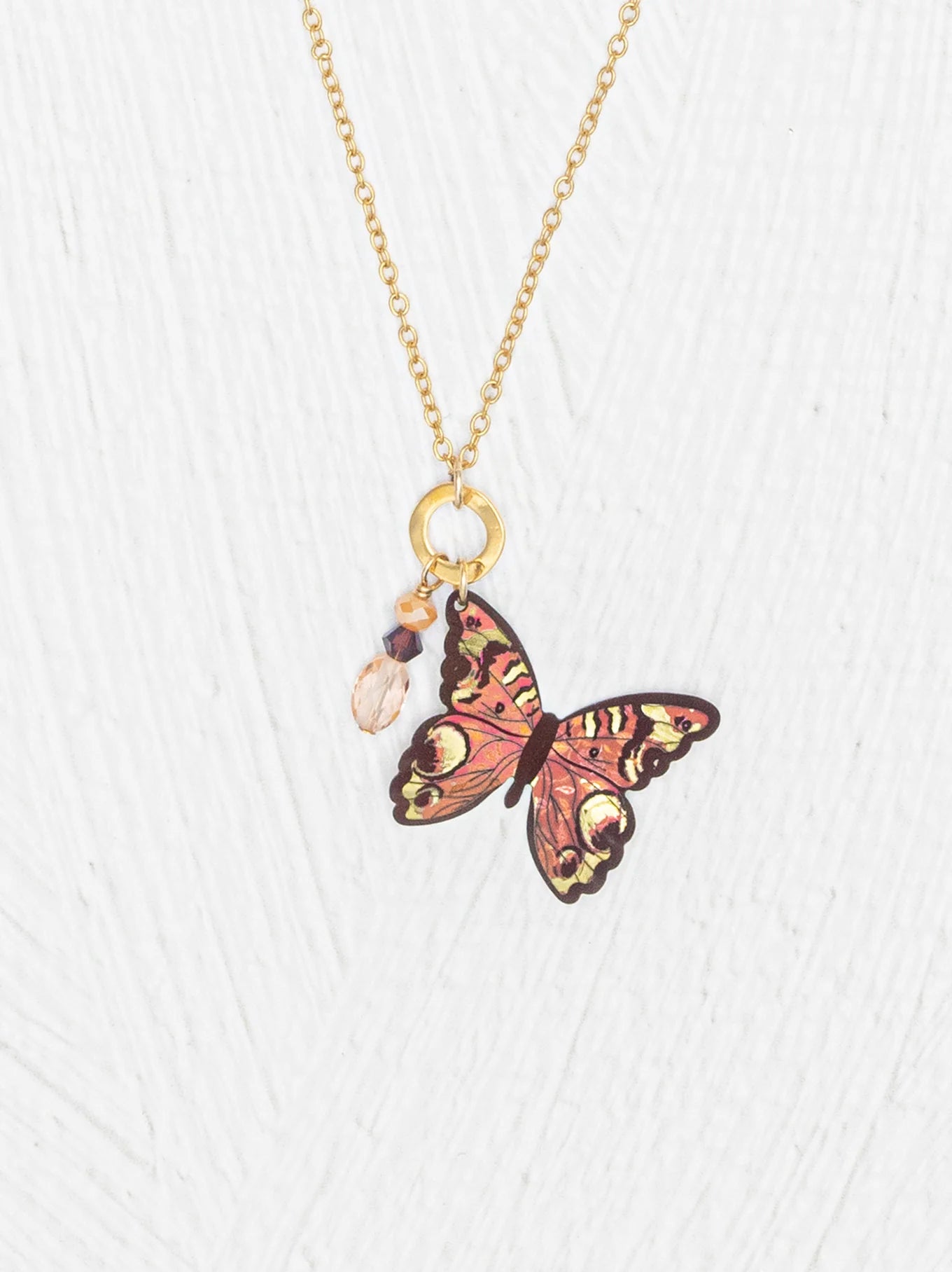 Close-up of the Mariposa Butterfly Charm Pendant Necklace, highlighting its intricate details, adjustable length, and unique handcrafted craftsmanship that creates a captivating shimmer in the light.
