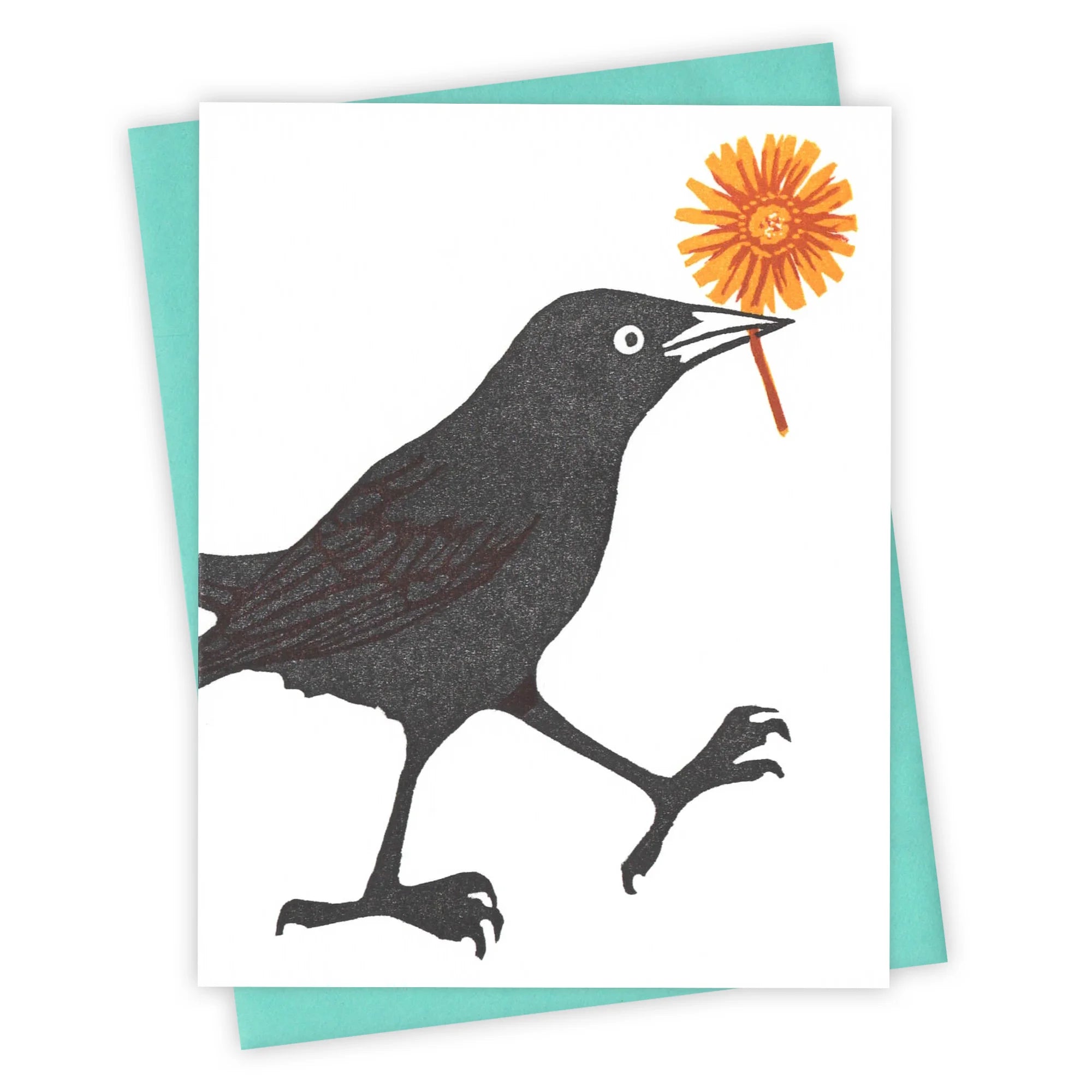 black bird holding an orange flower greeting card