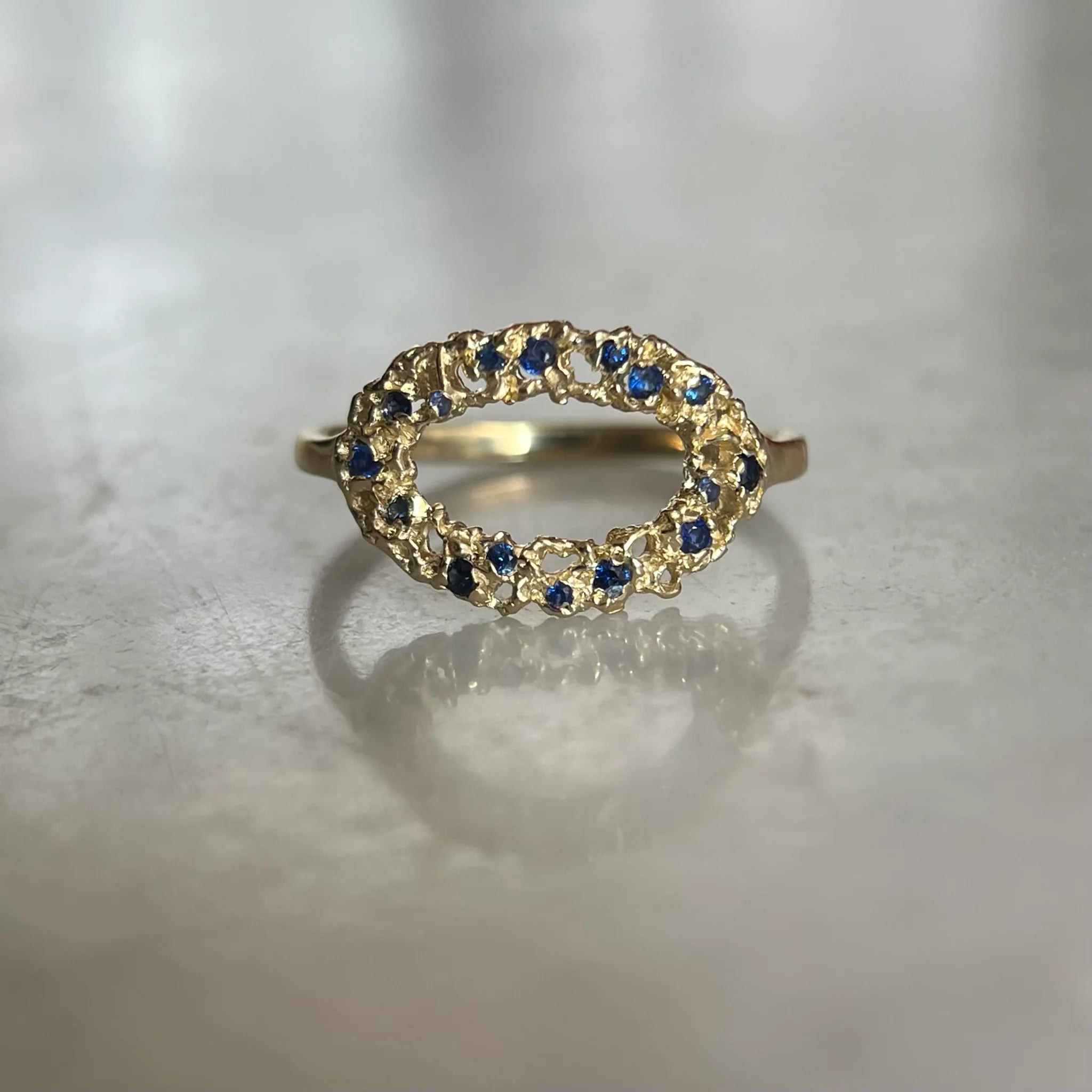 Gold clustered ring with blue gemstones 