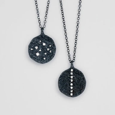 Two black stone pendants on chains 