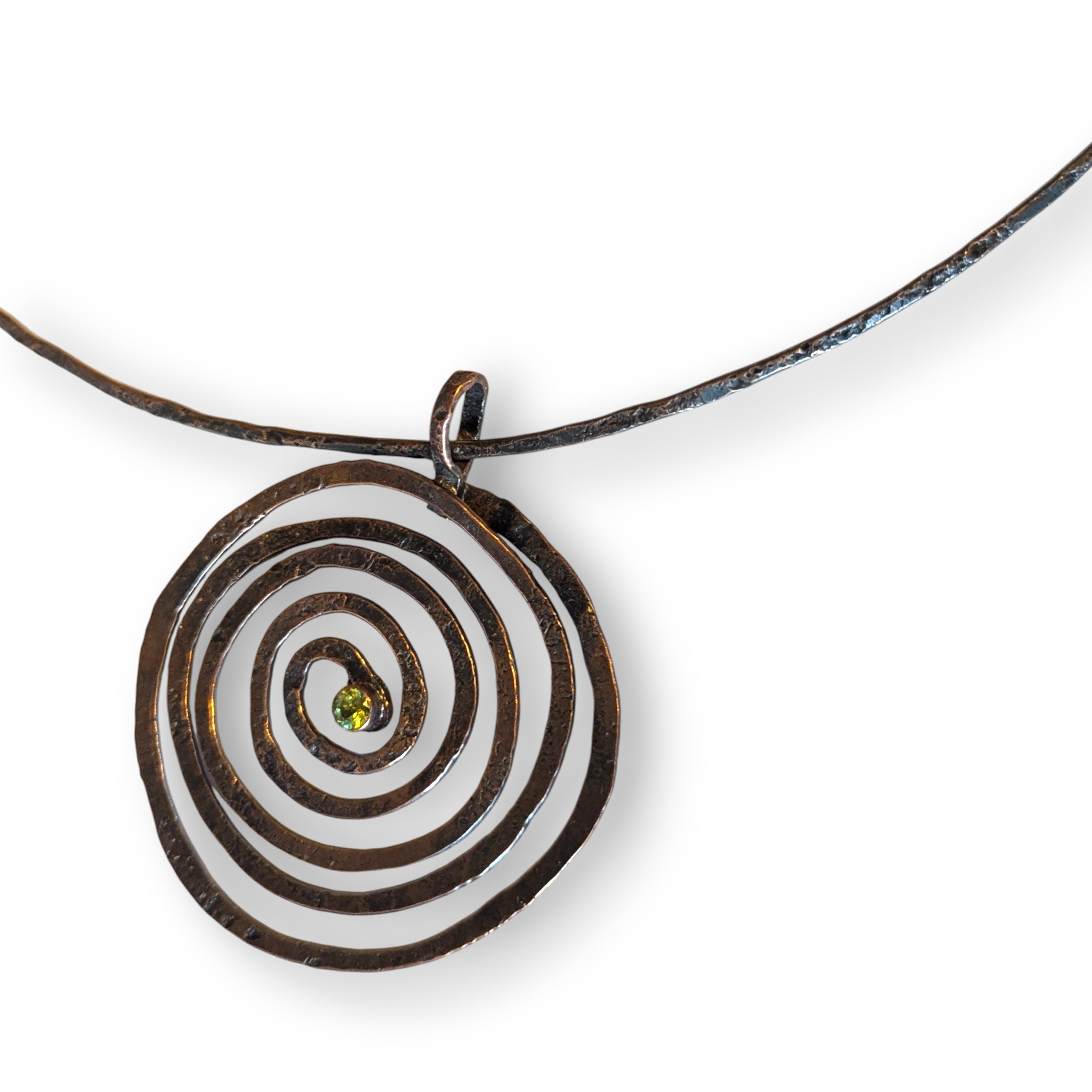 Spiral choker necklace with faceted peridot, handcrafted by Deb Collins, featuring a copper design inspired by organic shapes.