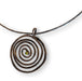 Spiral choker necklace with faceted peridot, handcrafted by Deb Collins, featuring a copper design inspired by organic shapes.