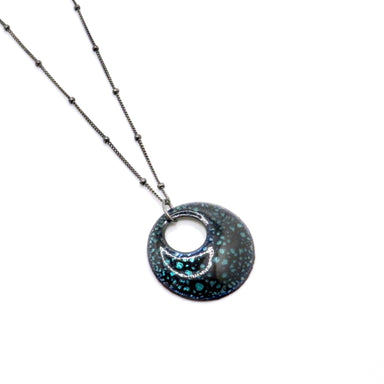 black pendant with green dots